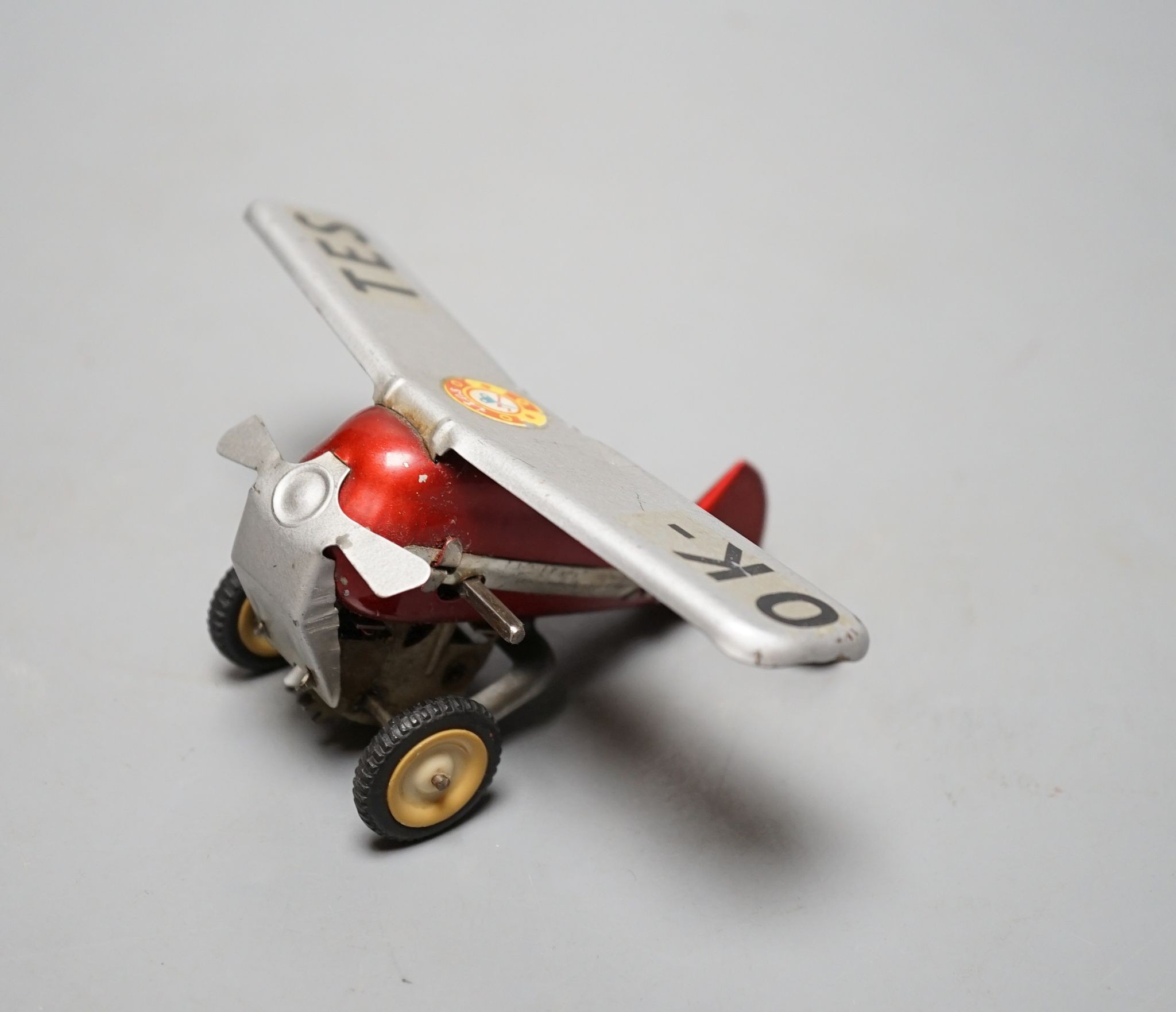 A Czech tinplate and clockwork model plane, wingspan 13 cms.